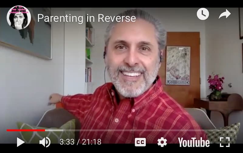 Parenting in Reverse A smiling man with gray hair and beard, wearing a red plaid shirt, sits in a living room during a video call. The screen shows Parenting in Reverse as the video title and the YouTube interface at the bottom.
