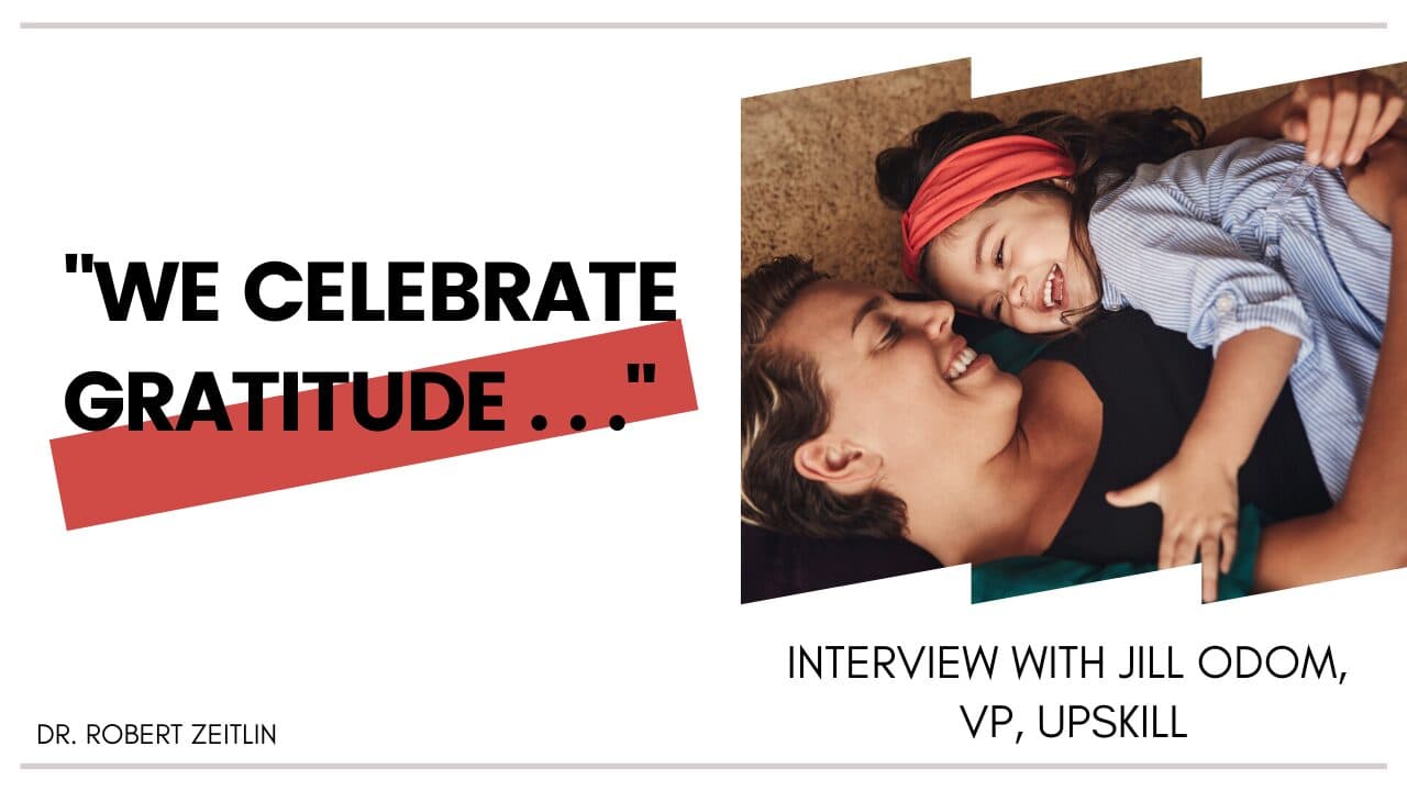 A smiling adult and child lie together, embracing and laughing. Beside them, large text reads We celebrate gratitude... with credits to Dr. Robert Zeitlin and an interview with Jill Odom, VP of Upskill.
